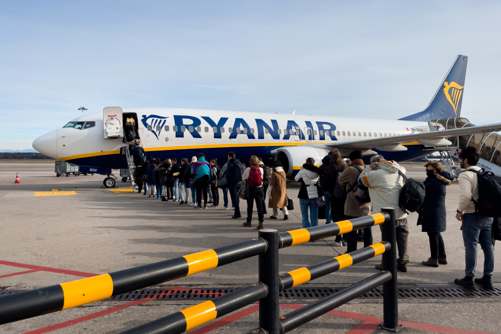 Passengers boarding a Ryanair commercial airplane at Milan Malpensa Airport in Italy