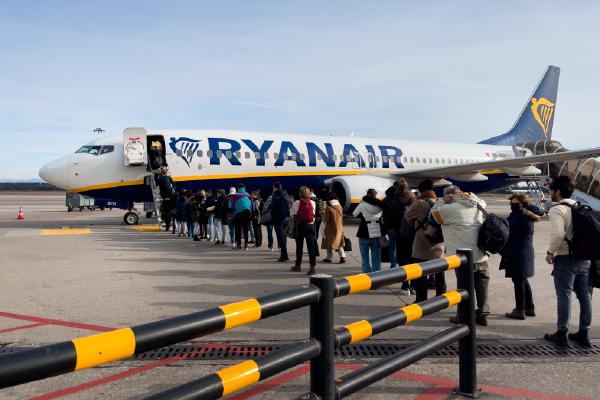 Passengers boarding a Ryanair commercial airplane at Milan Malpensa Airport in Italy