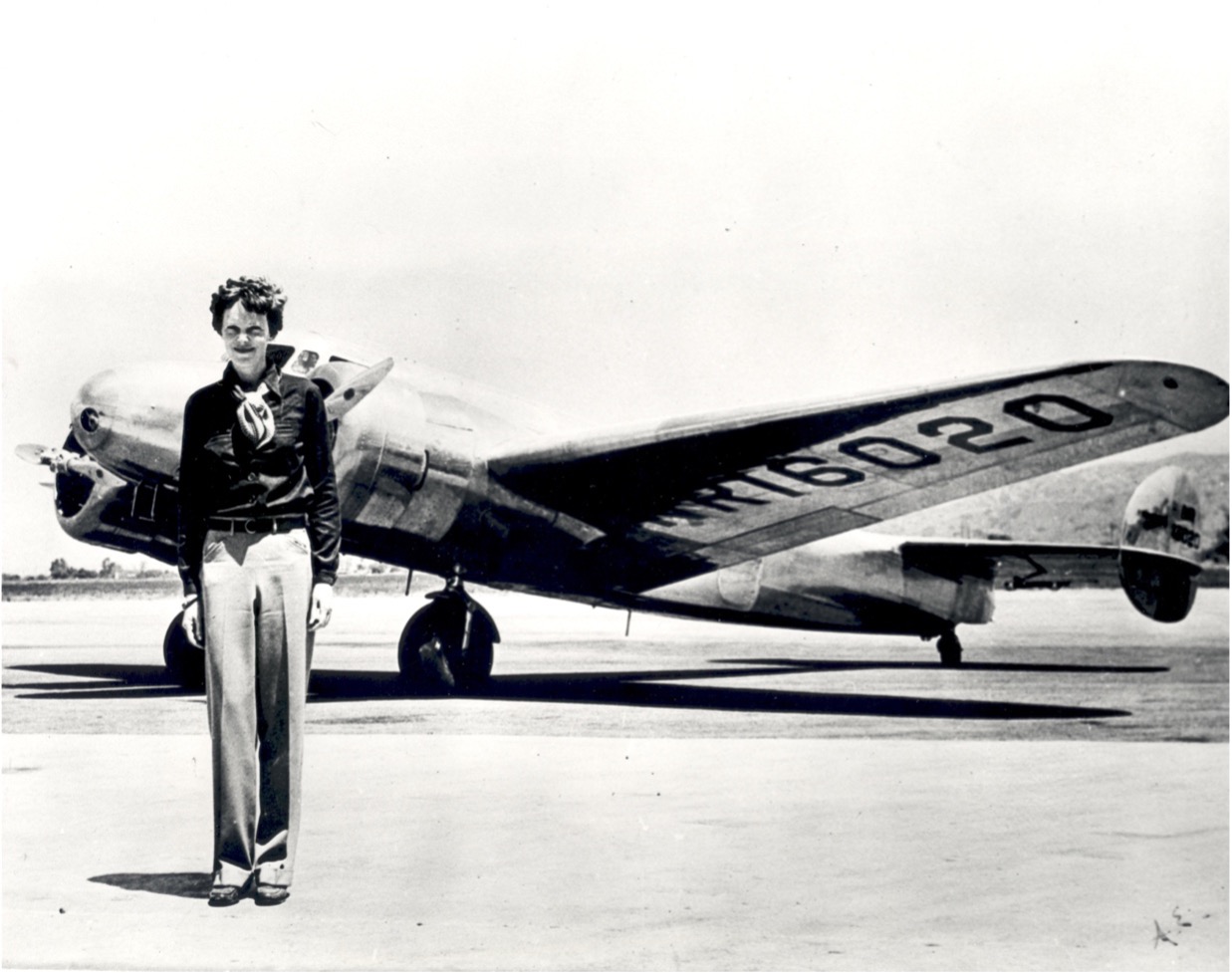 Amelia Earhart standing in front of the Lockheed Electra in which she disappeared in July 1937