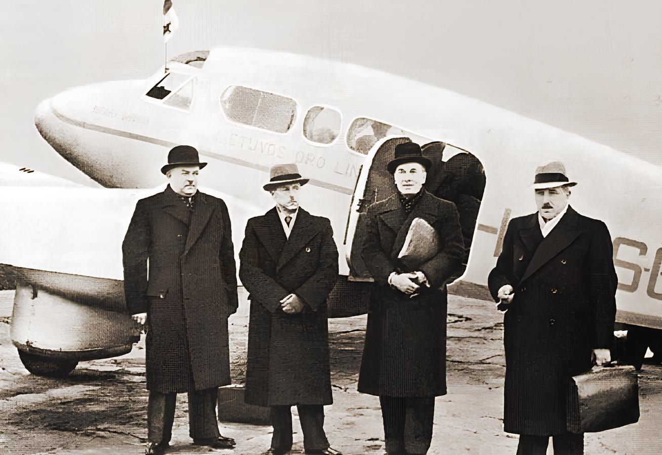 Lithuanian delegation, behind is a Percival Q.6 aircraft