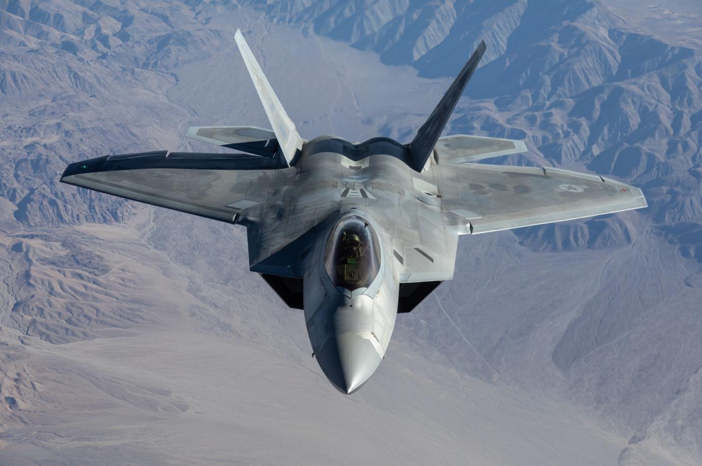 F-22 Raptor flying on top of the mountains