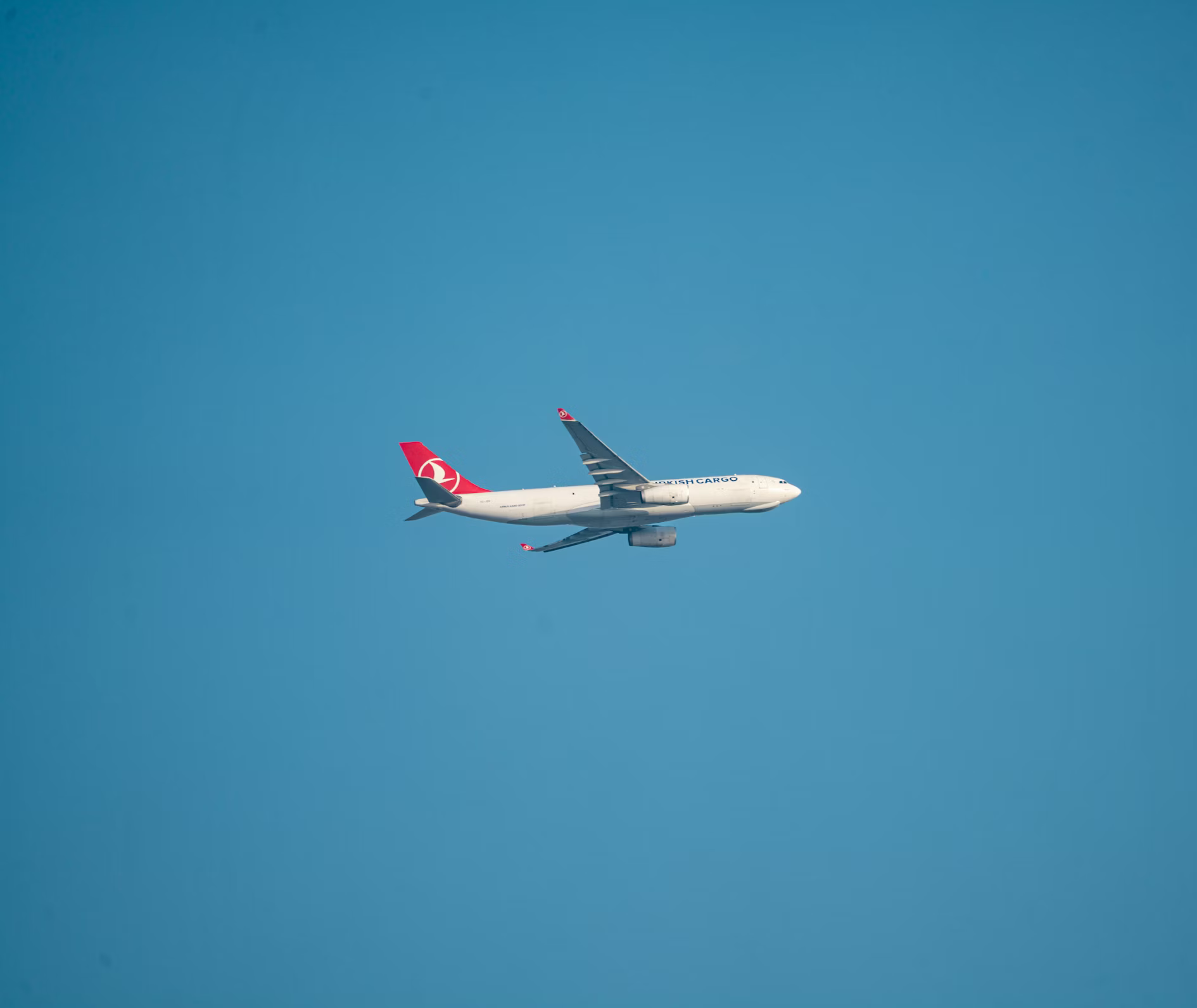 Airlines aircraft flying across a clear blue sky