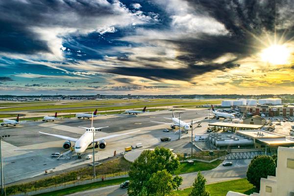 Highly edited photo of airport with planes and buildings in the background