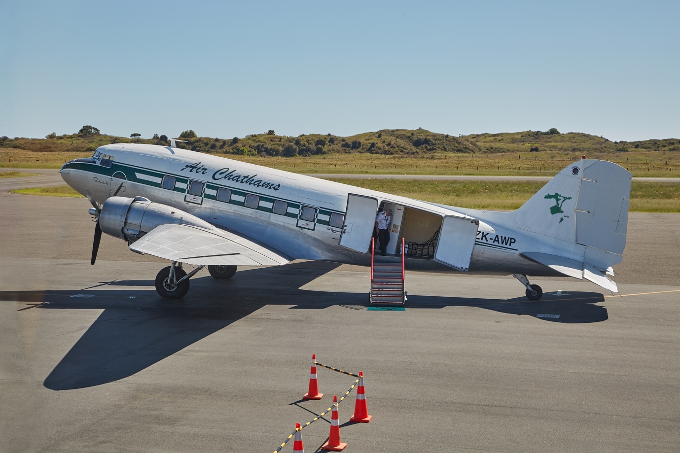 Douglas DC-3 standing on a runway sideview.