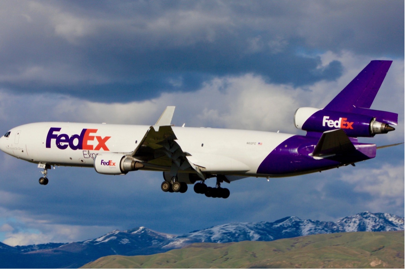 FedEx Express plane flying near the mountains