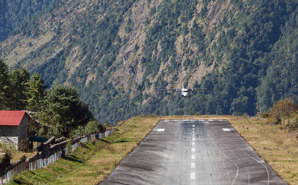 The aircraft is landing on the runway of the Tenzing-Hillary airport Lukla