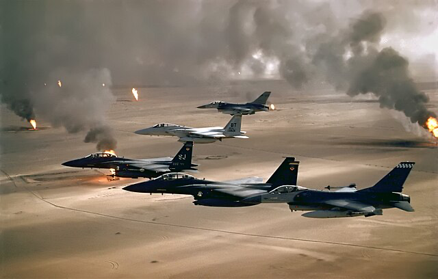 USAF aircraft of the 4th Fighter Wing (F-16, F-15C and F-15E) fly over Kuwaiti oil fires, set by the retreating Iraqi army during Operation Desert Storm in 1991.