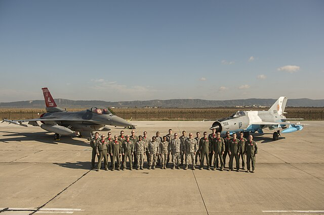 Members of the Alabama Air National Guard's 187th Fighter Wing pose for a photo in front of an F-16 Fighting Falcon and Romanian Air Force MiG-21 Lancer on 71st Air Base, Campia Turzii, Romania during Exercise Dacian Viper, Oct. 23, 2015.
